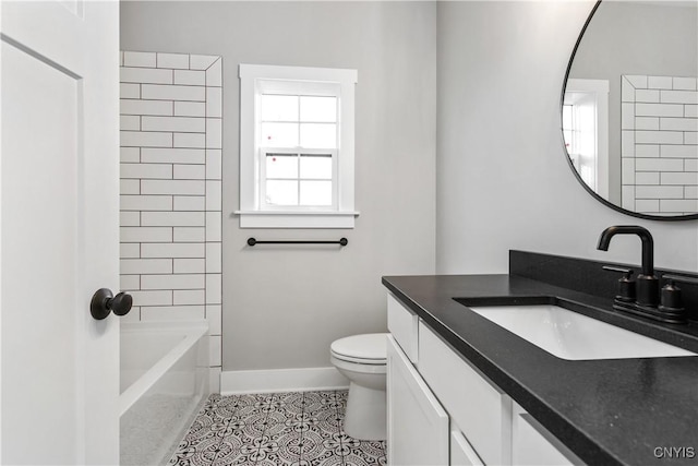 full bathroom featuring tiled shower / bath, tile patterned flooring, vanity, and toilet