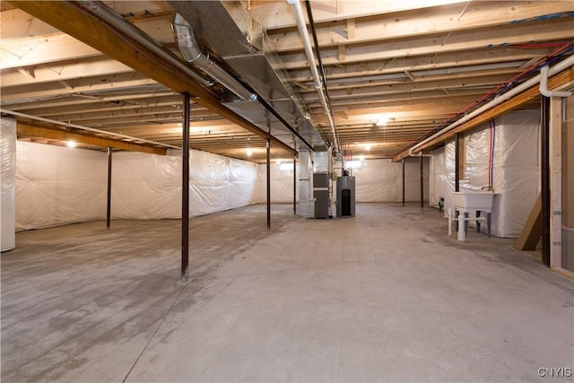 basement featuring water heater and heating unit