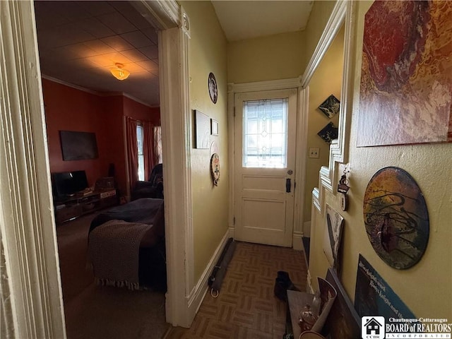 entryway featuring parquet floors and crown molding