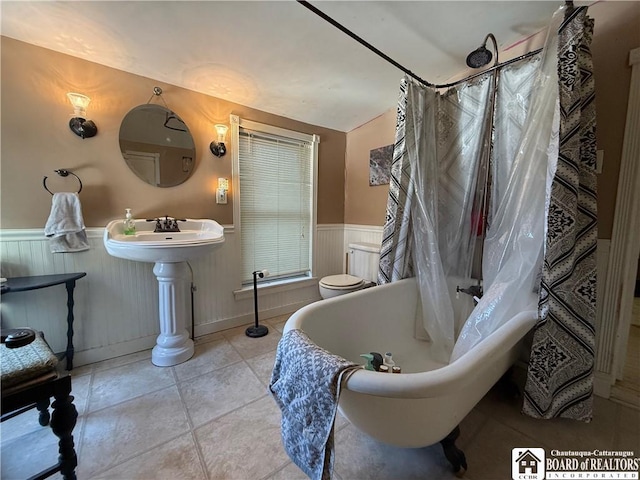 bathroom featuring toilet and tile patterned flooring