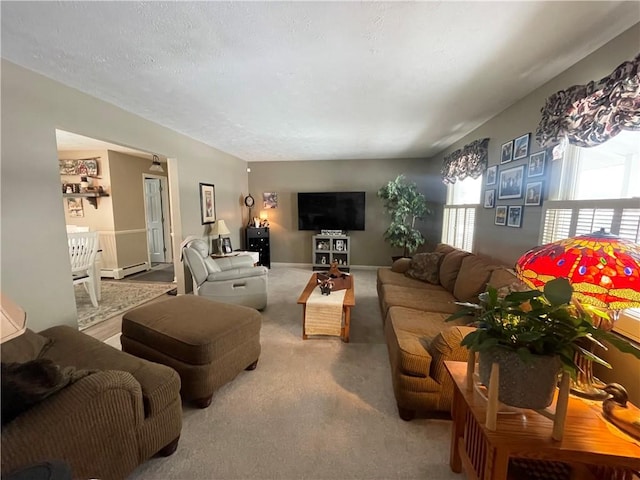 carpeted living room with a baseboard heating unit