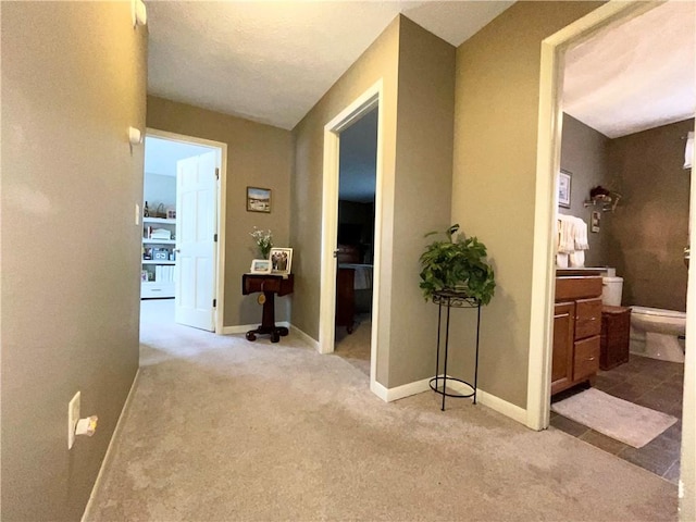 hall featuring light colored carpet