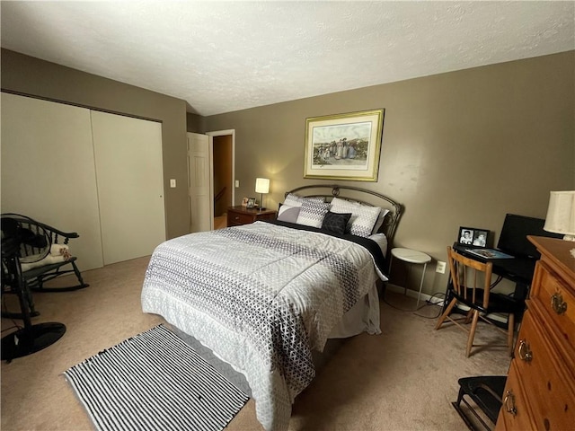 bedroom with light colored carpet, a closet, and a textured ceiling