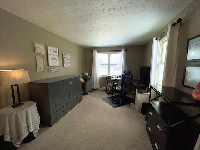 carpeted office space featuring a textured ceiling