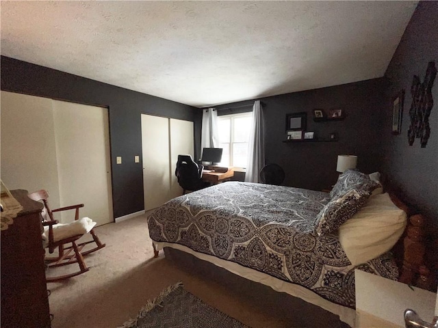 bedroom with light carpet and a textured ceiling