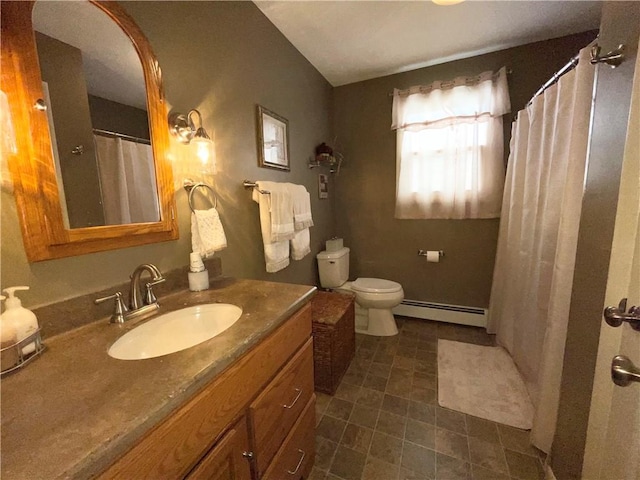 bathroom featuring toilet, vanity, and a baseboard radiator