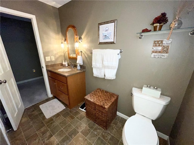 bathroom featuring toilet and vanity