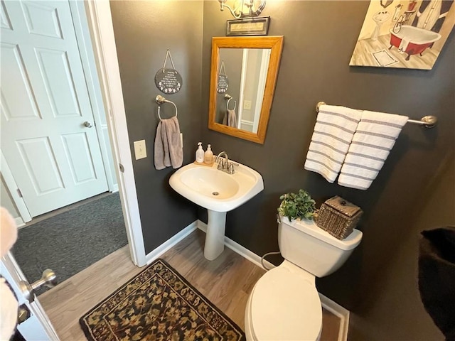 bathroom with wood-type flooring and toilet