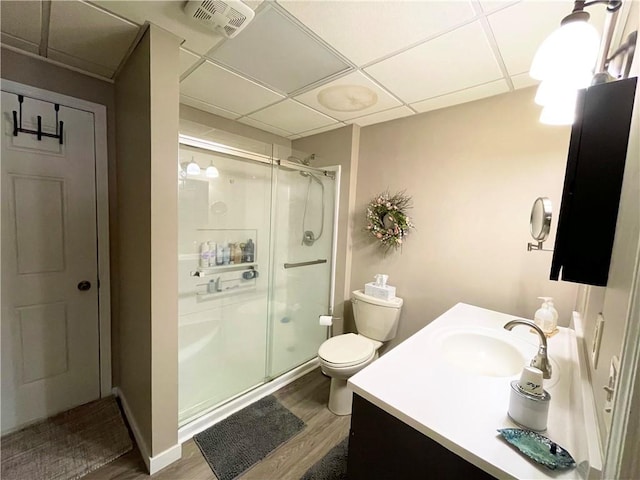 bathroom featuring an enclosed shower, vanity, toilet, and hardwood / wood-style floors