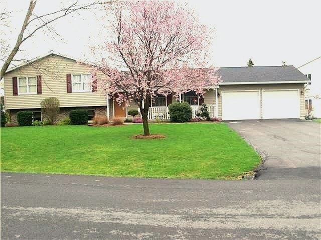 split level home featuring a front yard and a garage