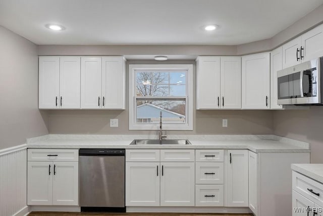 kitchen with sink, white cabinetry, and appliances with stainless steel finishes