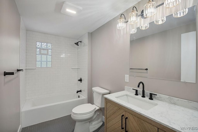 full bathroom featuring toilet, tiled shower / bath combo, and vanity