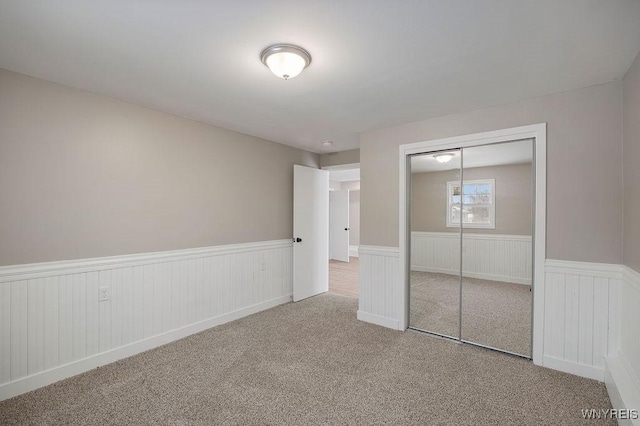 unfurnished bedroom with a closet and carpet flooring