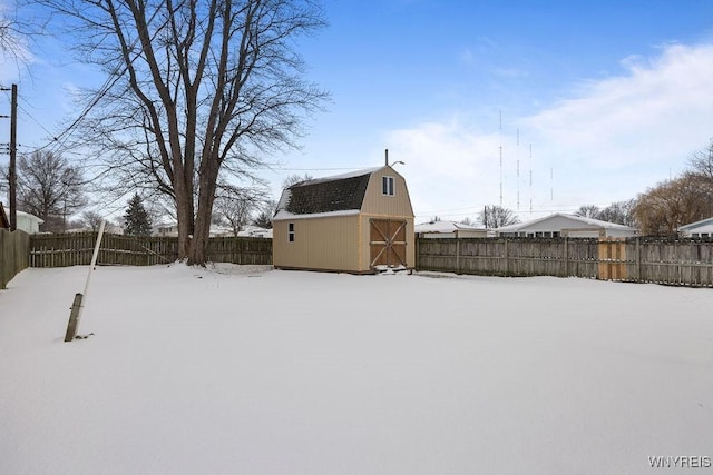 yard covered in snow featuring a shed