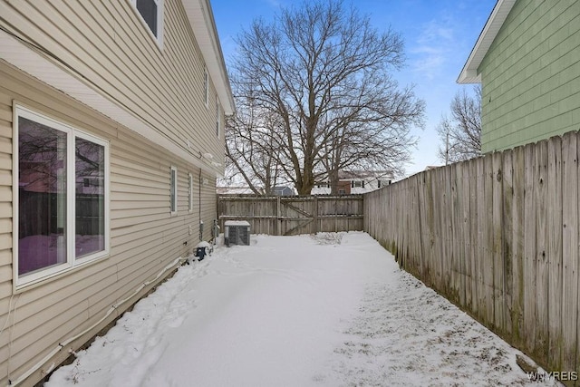 snowy yard with central AC unit