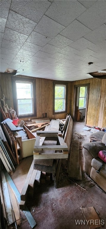 miscellaneous room featuring wood walls