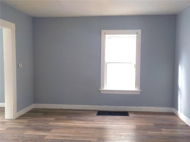 unfurnished room with hardwood / wood-style flooring