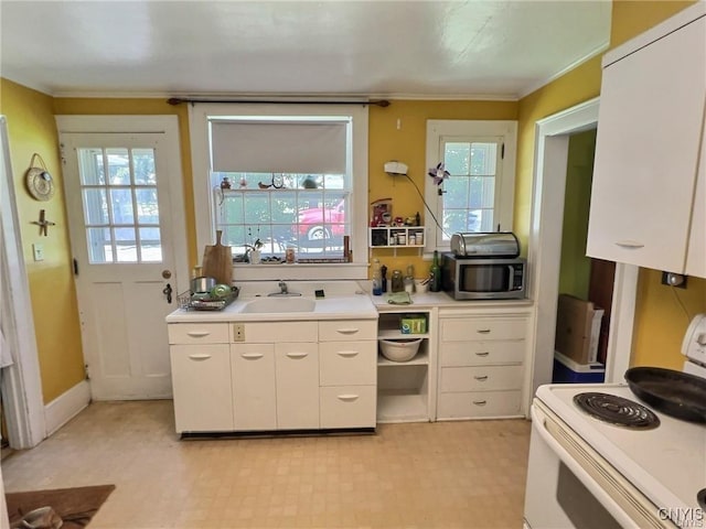 kitchen featuring sink, white cabinetry, and white range with electric cooktop