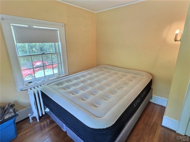 bedroom featuring dark wood-type flooring and crown molding