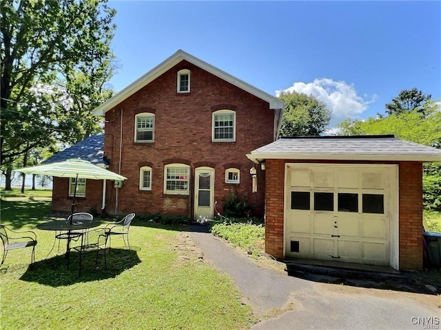 front facade featuring a front yard and a garage