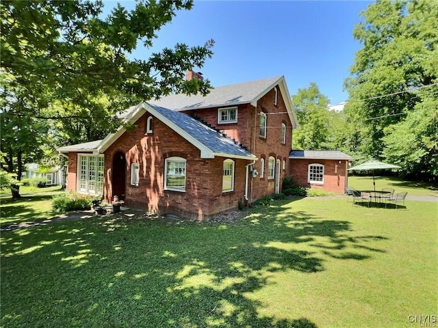 back of house with a lawn