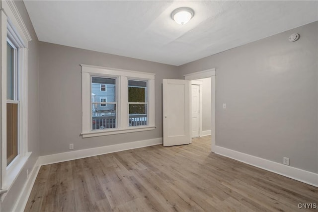 spare room with light wood-type flooring