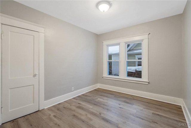 empty room with light hardwood / wood-style flooring