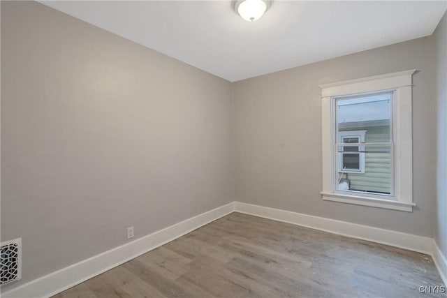 unfurnished room with wood-type flooring