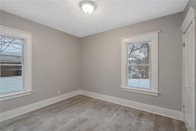 unfurnished room with hardwood / wood-style flooring