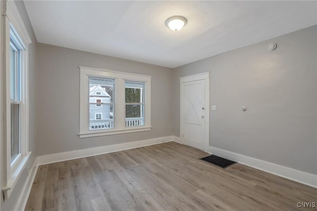 unfurnished room with light hardwood / wood-style flooring