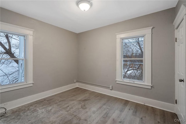 empty room with hardwood / wood-style floors