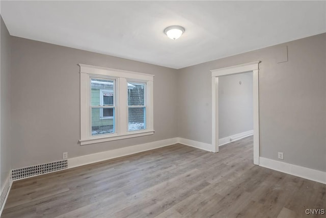 spare room with light hardwood / wood-style floors