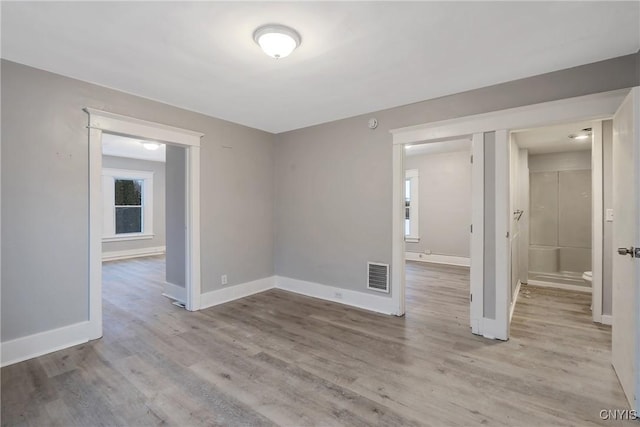 unfurnished room with light wood-type flooring