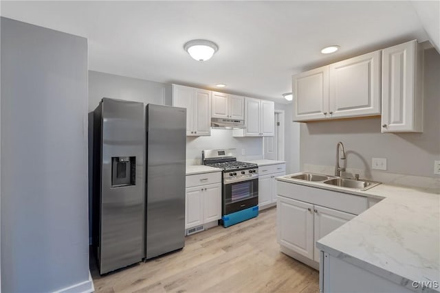 kitchen featuring stainless steel appliances, white cabinets, and sink