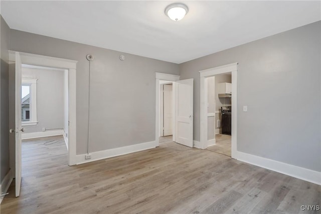 unfurnished bedroom featuring light hardwood / wood-style floors and a closet