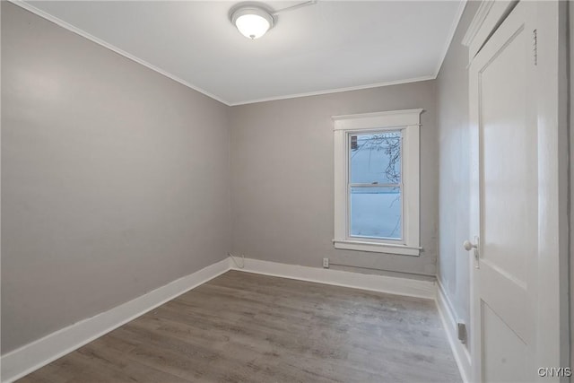 unfurnished room with hardwood / wood-style floors and ornamental molding