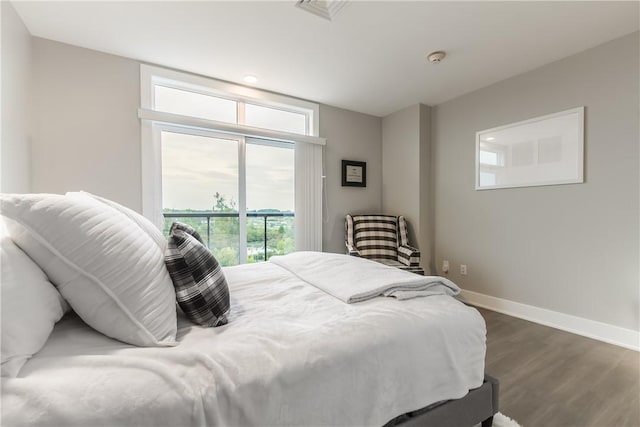 bedroom with dark hardwood / wood-style flooring