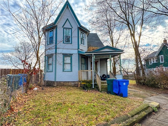 victorian home featuring a front yard