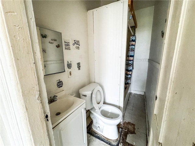 bathroom featuring toilet and vanity