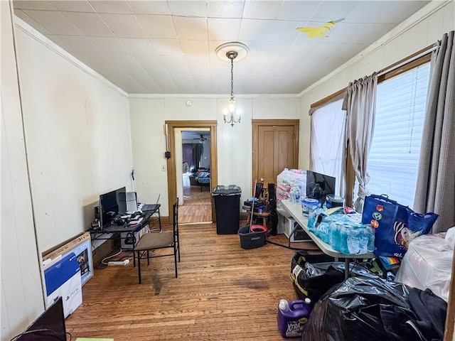 home office featuring a chandelier, hardwood / wood-style floors, and crown molding