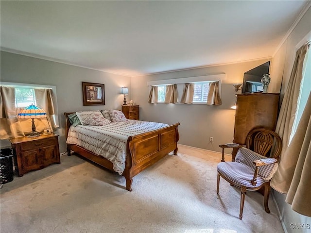 bedroom with multiple windows, crown molding, and carpet flooring