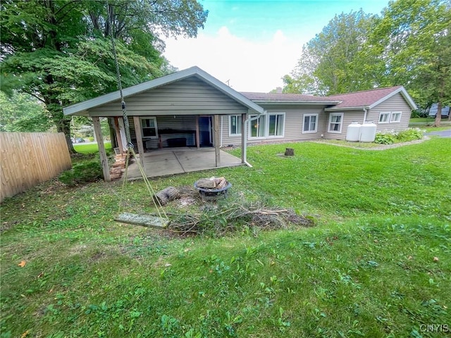 back of property featuring a lawn and a carport