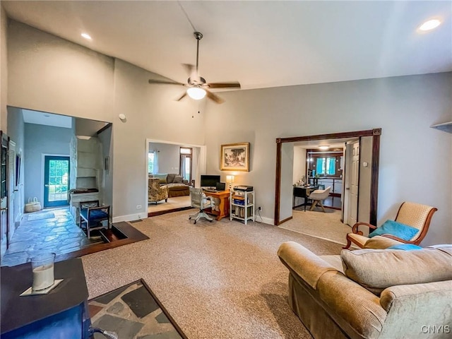 living room with ceiling fan, high vaulted ceiling, and carpet floors