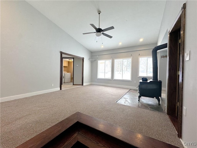 living room featuring lofted ceiling, washer / clothes dryer, ceiling fan, and light colored carpet