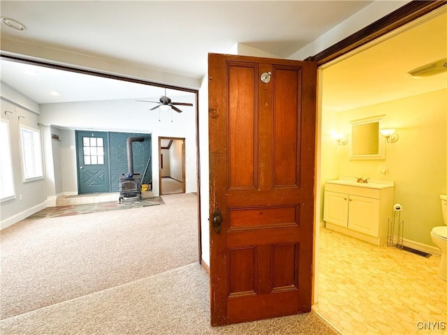 corridor featuring sink and light carpet