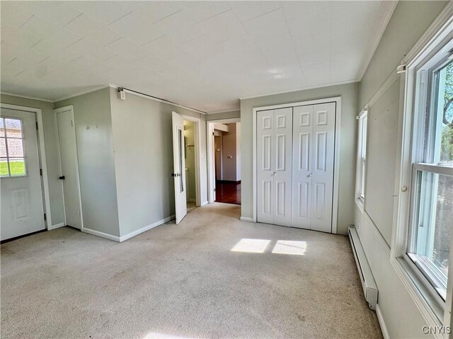 5902 N Rd, Owasco, NY 13021 - unfurnished bedroom featuring carpet flooring, a baseboard heating unit, crown molding, and baseboards