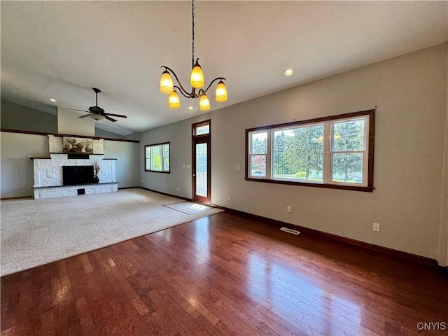 5902 N Rd, Owasco, NY 13021 - unfurnished living room with wood finished floors, a ceiling fan, lofted ceiling, baseboards, and a chandelier