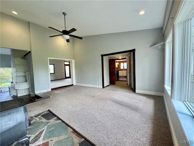 5902 N Rd, Owasco, NY 13021 - unfurnished living room featuring baseboards, carpet, recessed lighting, and a towering ceiling