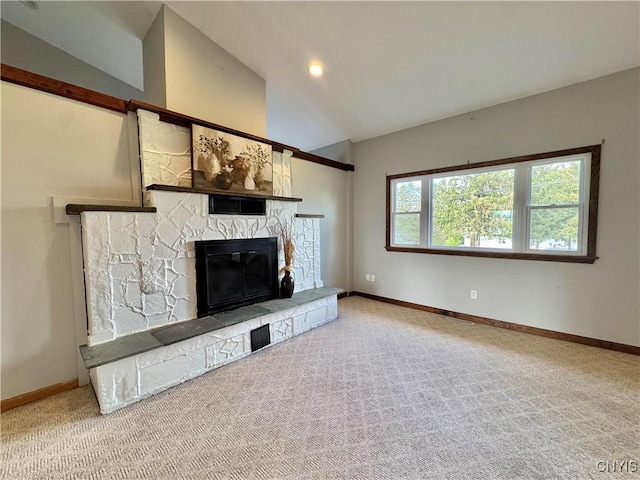 5902 N Rd, Owasco, NY 13021 - unfurnished living room with vaulted ceiling, a stone fireplace, baseboards, and carpet floors