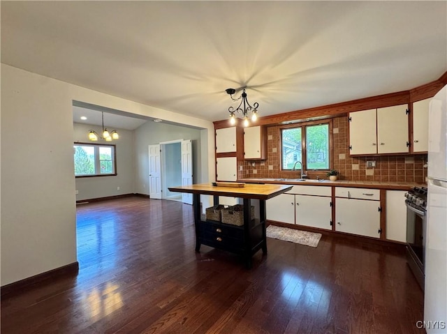 5902 N Rd, Owasco, NY 13021 - kitchen with a chandelier, a sink, plenty of natural light, and backsplash